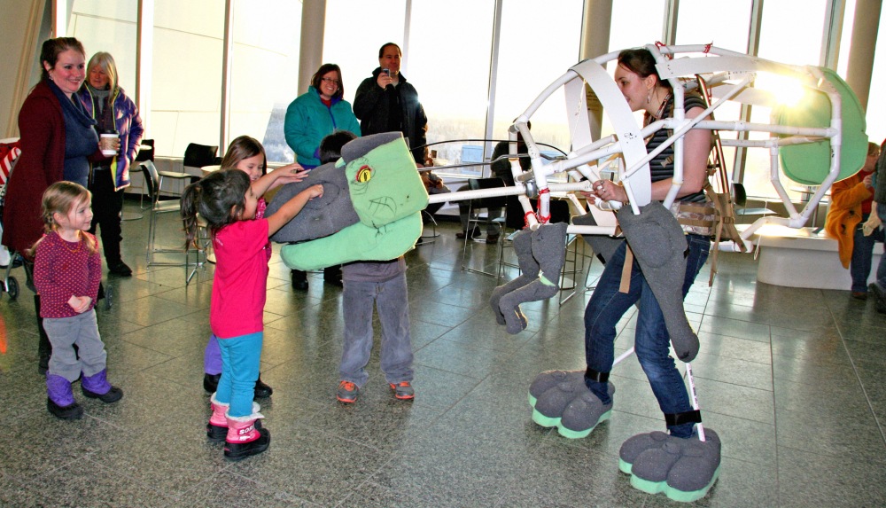 Animator Hannah Foss introduces Snaps, the animatronic dinosaur, to the community at the museum's Open House in January 2015.